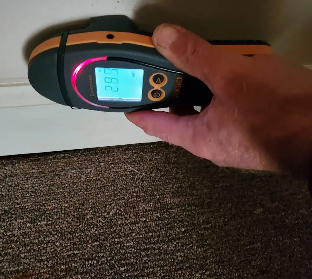 Moisture detection at baseboard during Storm Damage Restoration in Wilmington